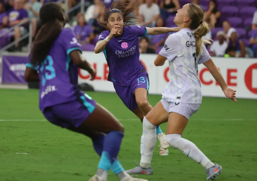 Orlando player Jacquie Ovalle (middle) has an intense look on...