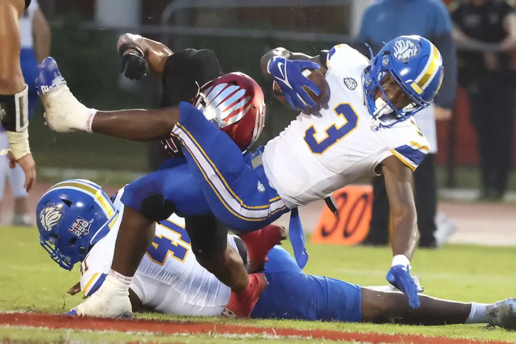 TFA running back Hyquez Russell (3) falls forward during the...