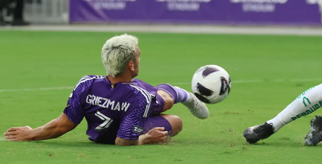 Orlando player Antoine Griezmann tries to kick the ball toward...