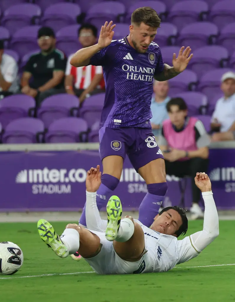 Orlando player Marco Pasalic (87) knocks down Atletico player Benjamin...