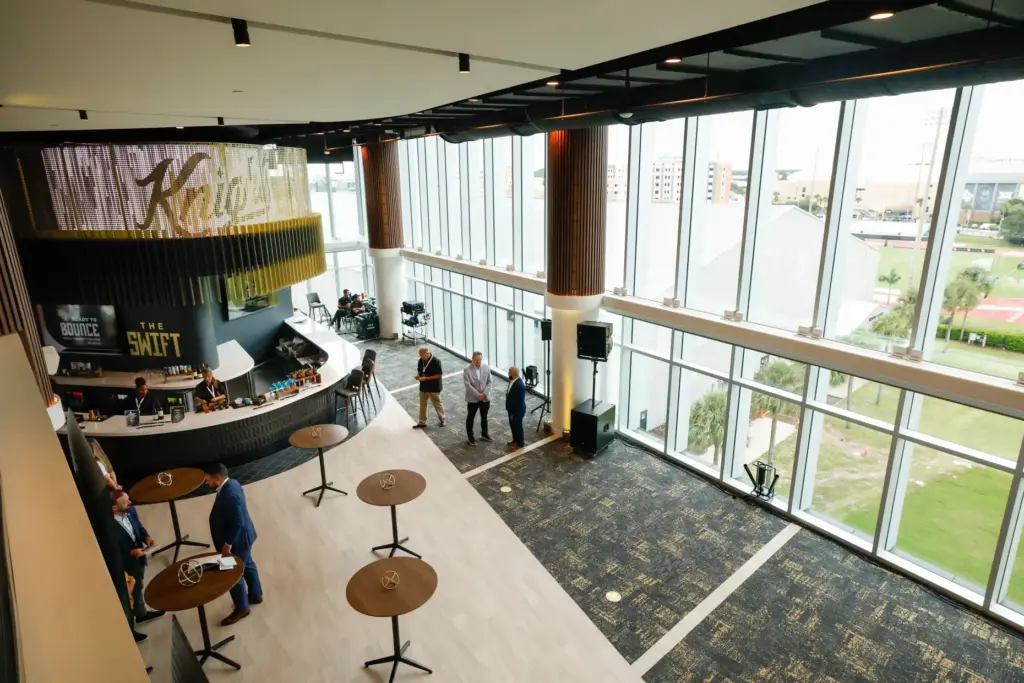 Looking down into the indoor lounge at the Roth Tower at Acrisure Bounce House Stadium, pictured during a preview tour on Thursday, August 20, 2026, of the new tower space that houses expanded indoor and outdoor luxury suites and lounges overlooking the UCF football field. (Rich Pope/Orlando Sentinel)