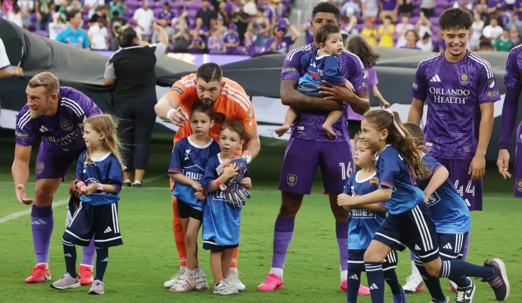 Orlando players are pictured with kids before the Club Leon...