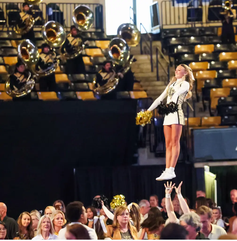 University of Central Florida cheerleaders and marching band perform during...