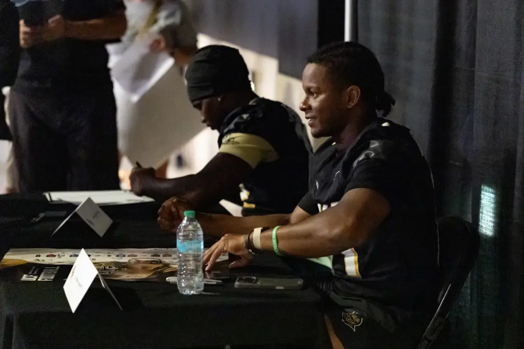 Knightâs Quarterbacks Alonza Barnett III, front, and Keyone Jenkins sign...