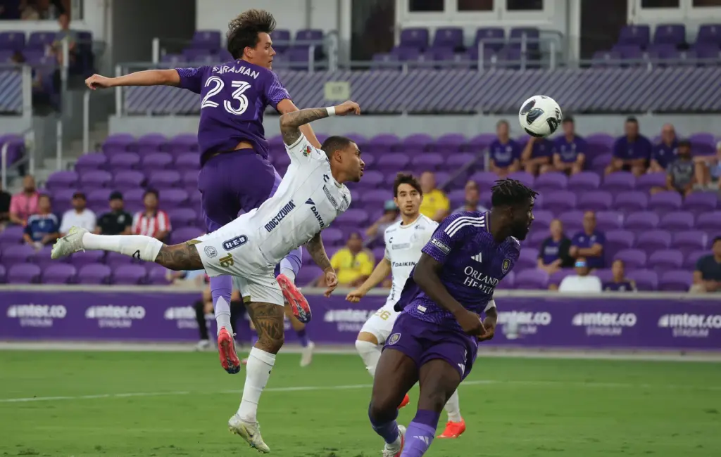Orlando player Harvey Sarajian (23) heads the ball over Atletico...