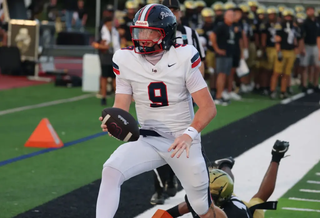 Lake Brantley quarterback Jackson Stecher leaps into the endzone for...