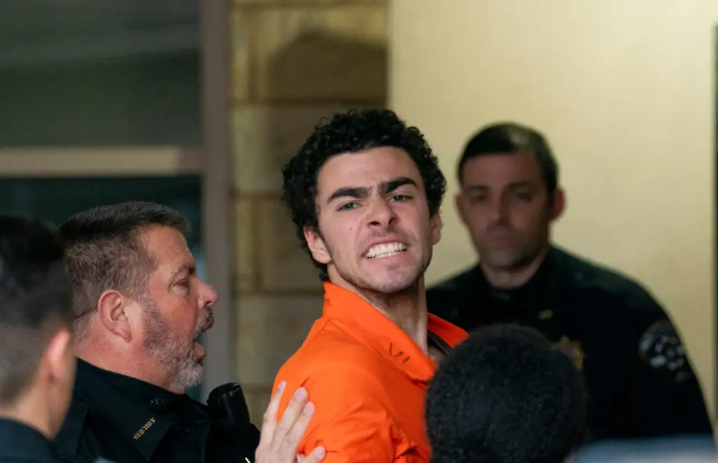 Suspect Luigi Mangione is taken into the Blair County Courthouse.
