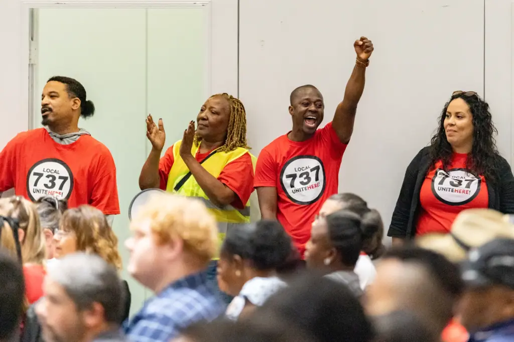 Local 737 Union member cheers with the crowd of union...
