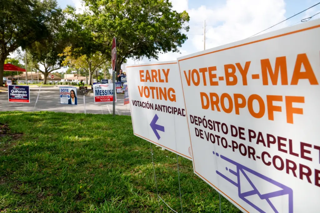 Early voting and campaign signs line the entrance to the...