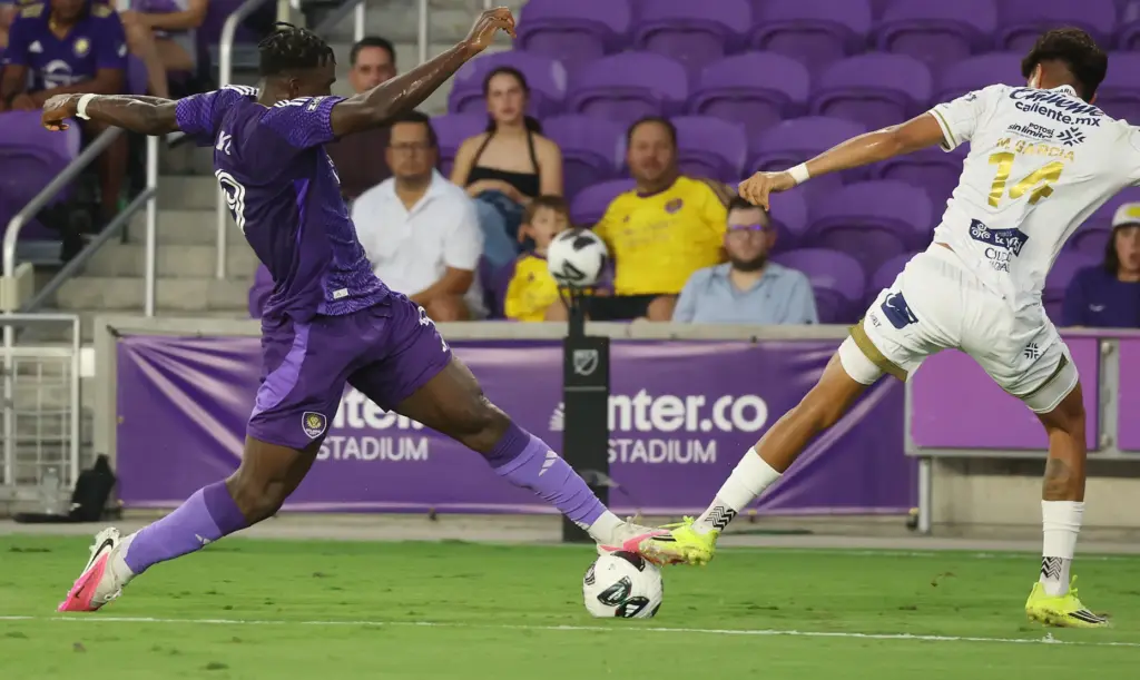 Orlando player Daryl Dike (left) reaches to take the ball...