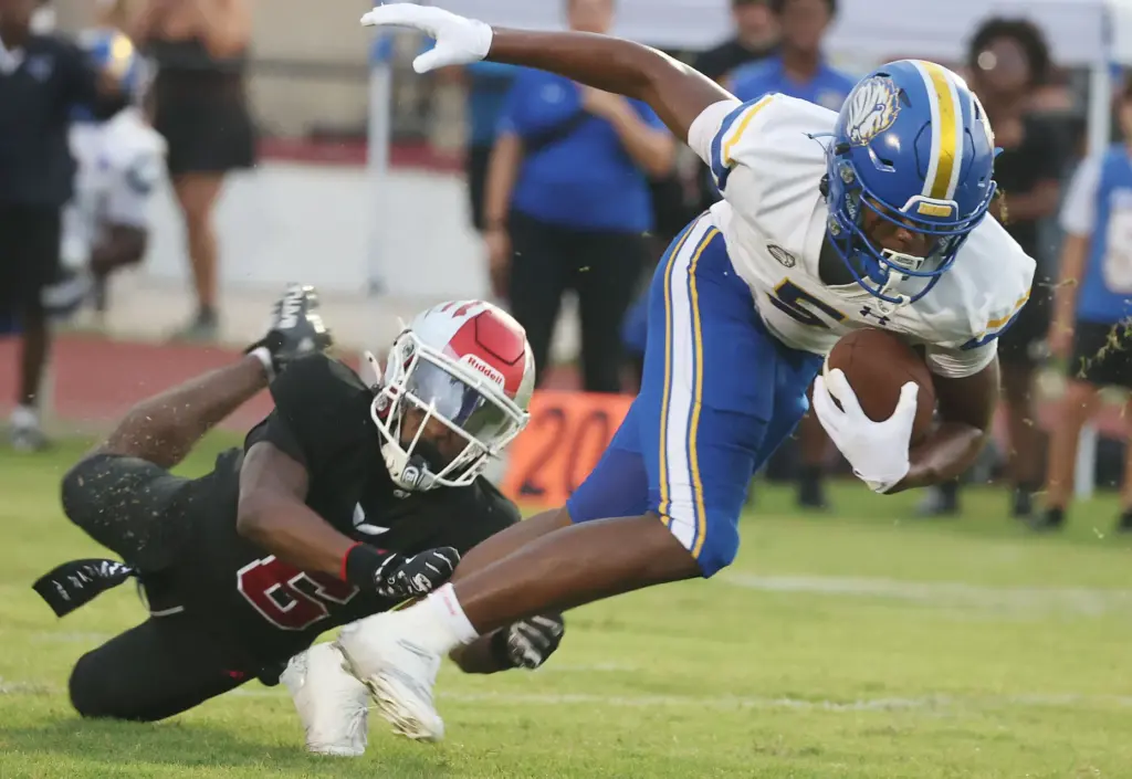 TFA receiver Jaylen Johnson (5) runs away from Edgewater safety...