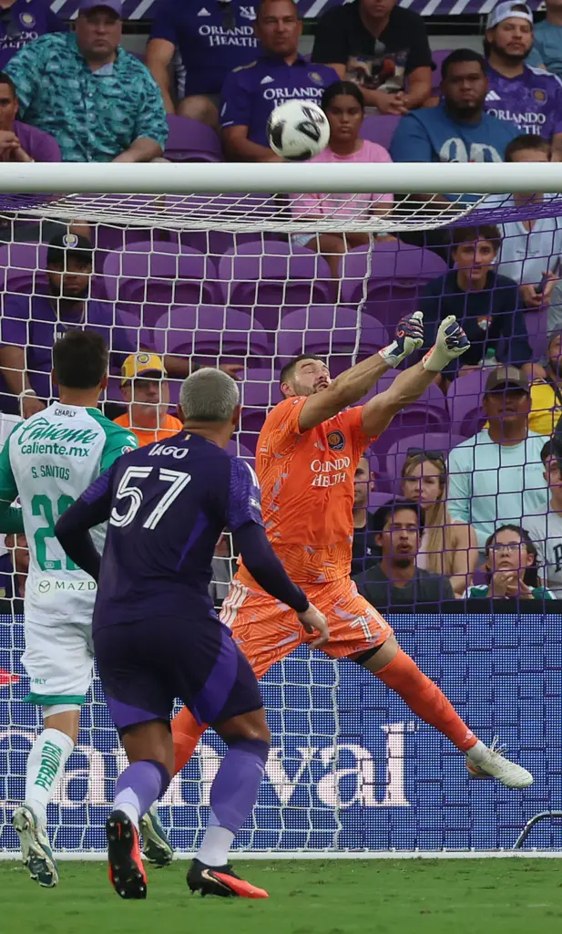 Orlando goalkeeper Maxime Crepeau leaps to stop a goal attempt...