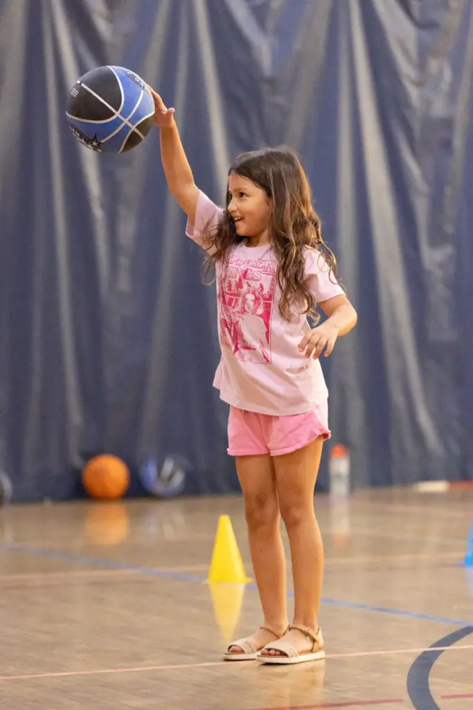 Mila Duque practices her basketball dribbling in the free sports...