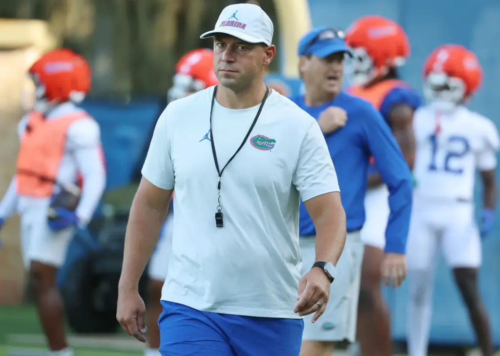 University of Florida head coach Jon Sumrall eyes the media...