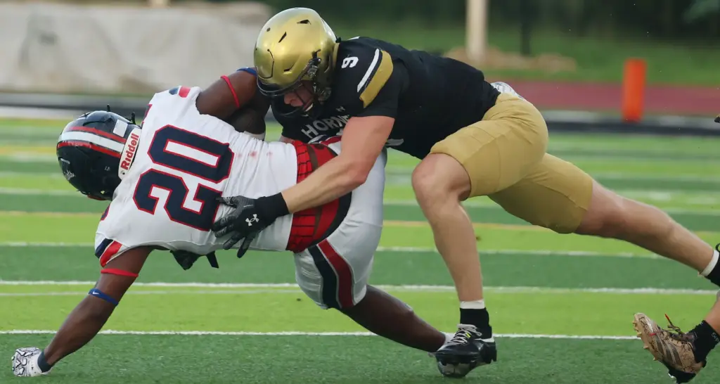 Bishop Moore linebacker Cale Britt (9) tackles Lake Brantley running...