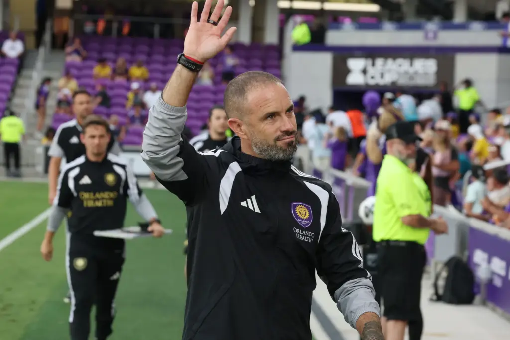 Orlando head coach Martin Perelman waves as he walks onto...