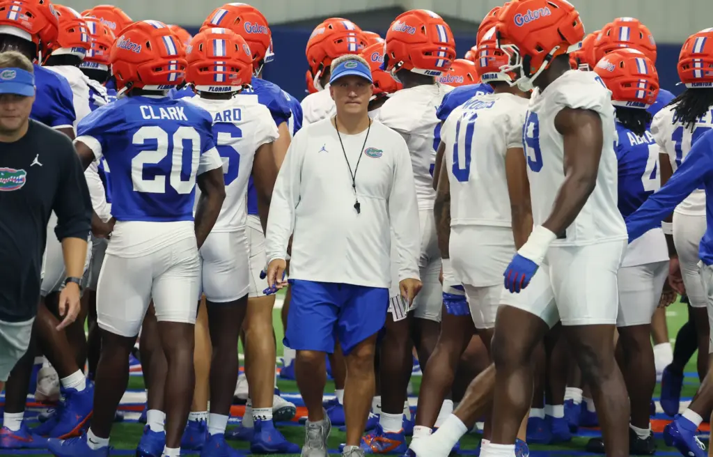 University of Florida offensive coordinator Buster Faulkner (middle) is pictured...