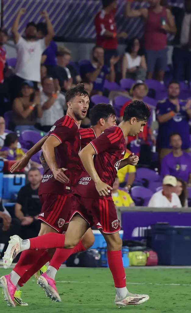Orlando player David Brekalo (left) celebrates after scoring a goal...
