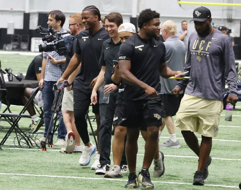 UCF players walk between stations during UCF Football Media Day...