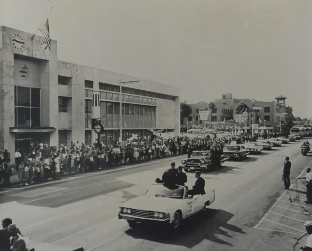 The presidential caravan of Lyndon B. Johnson drives down Orange...