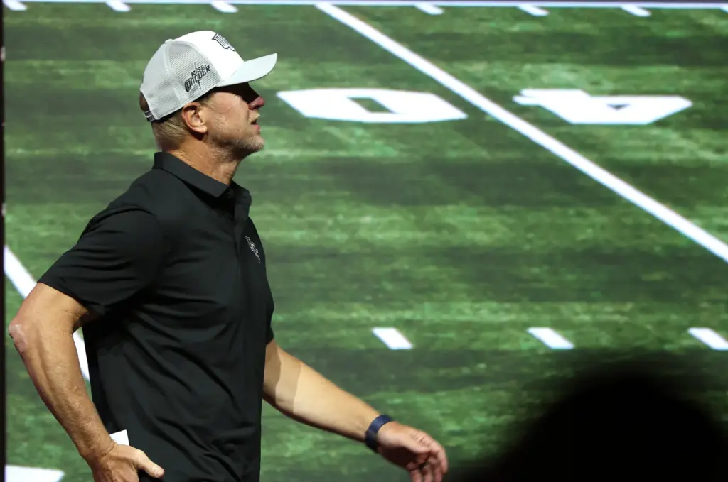 University of Central Florida football coach Scott Frost takes the...