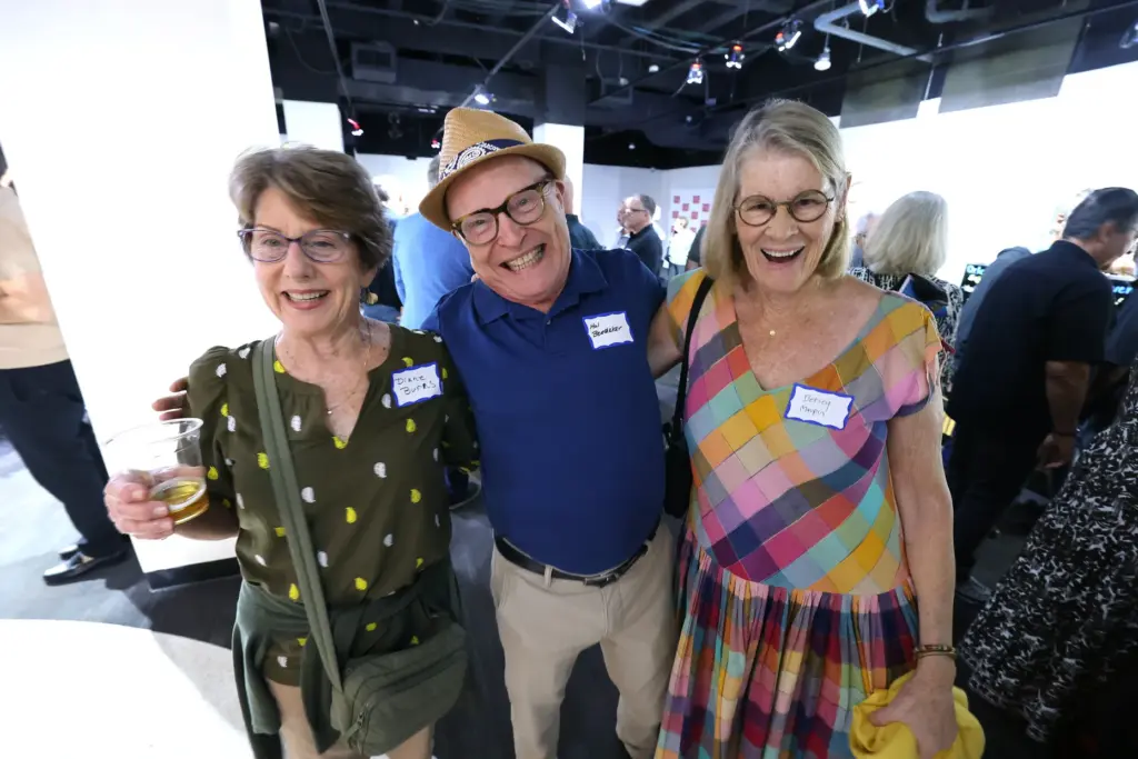 Former and current Orlando Sentinel journalists and employees are pictured...