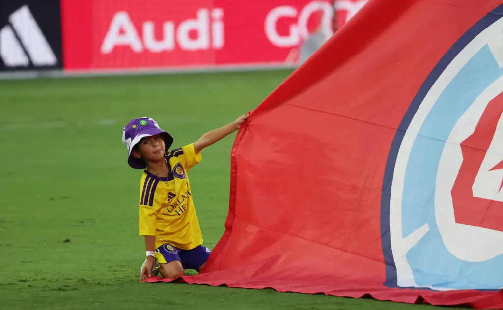 A child holds down a banner before the Chicago Fire...