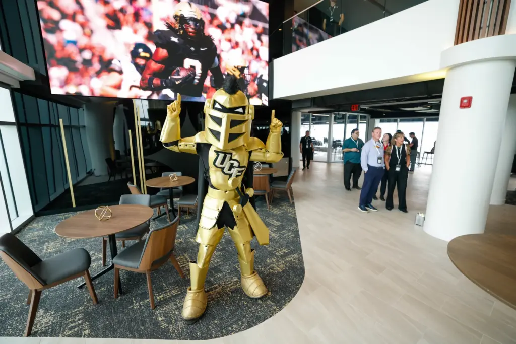 UCF mascot Knightro in front of the large screen for...