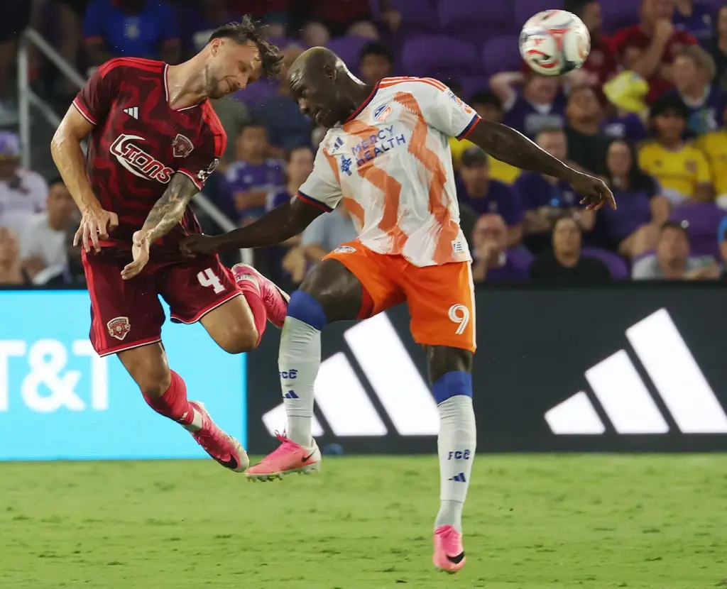 Orlando City's David Brekalo, left, and FC Cincinnati's Kevin Denkey...