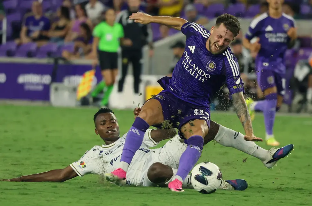 Orlando player Marco Pasalic (87) is fouled by Atletico player...