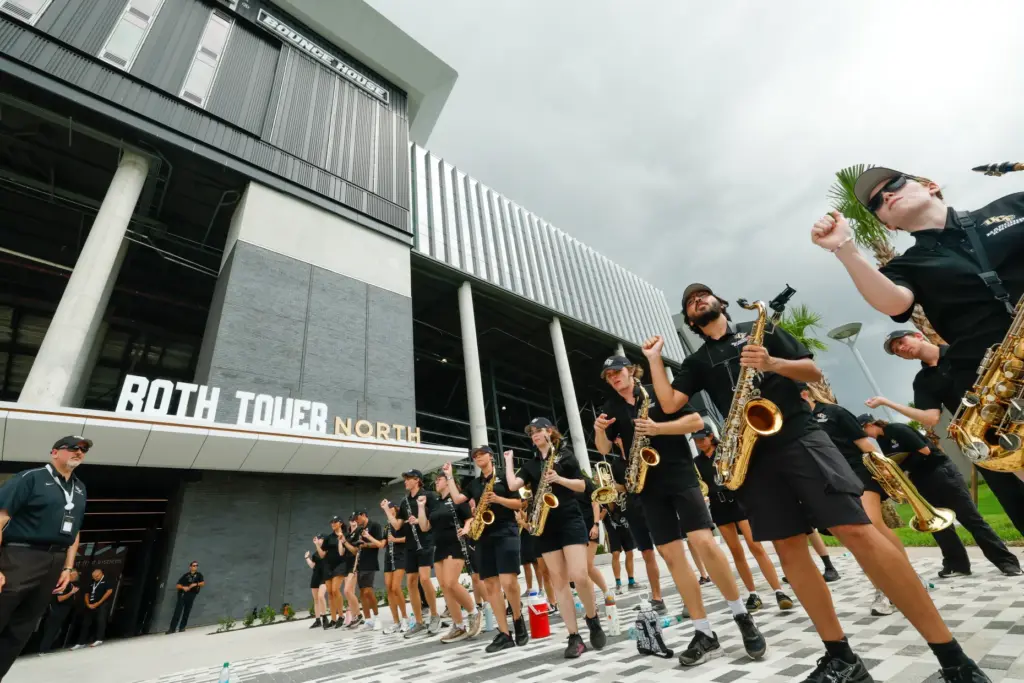 Members of UCF Marching Knights welcome individuals to the Roth...