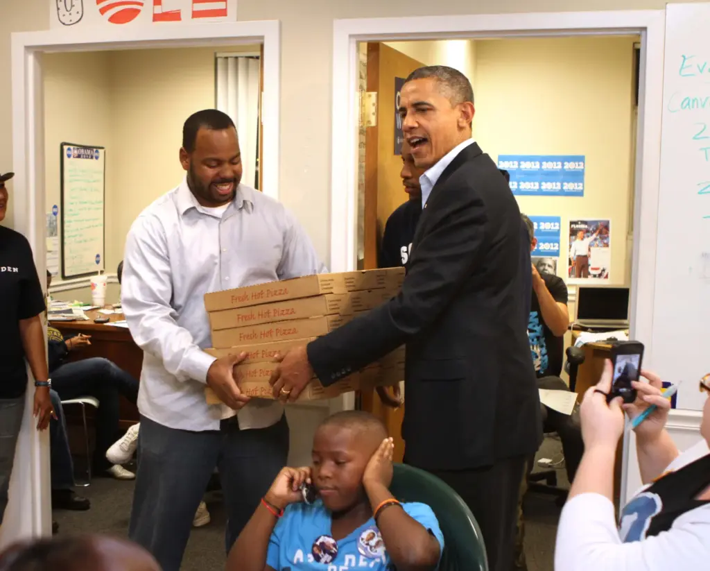 President Barack Obama surprises workers at the Obama For America...