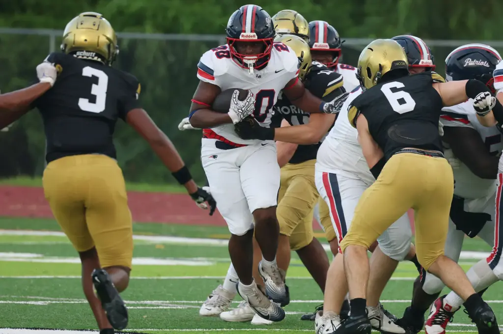 Lake Brantley running back KJ Bradford (20) runs through the...