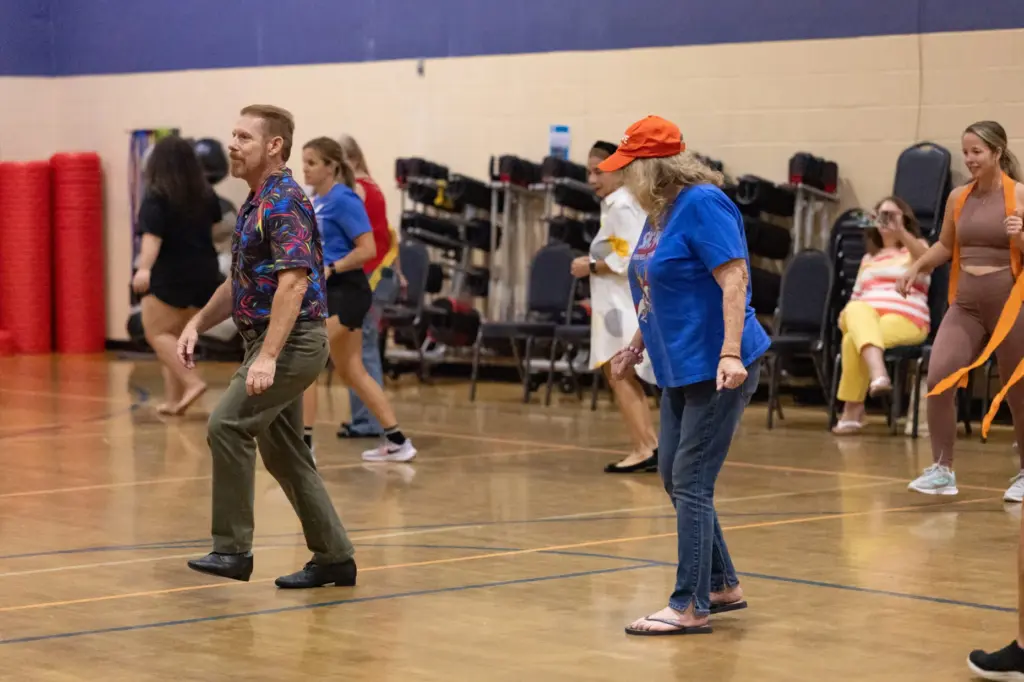 World Champion Ballroom Dancer Richard Lamberty, left, teaches a dance...
