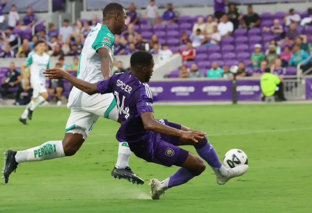 Orlando player Tyrese Spicer (14) kicks at goal during the...