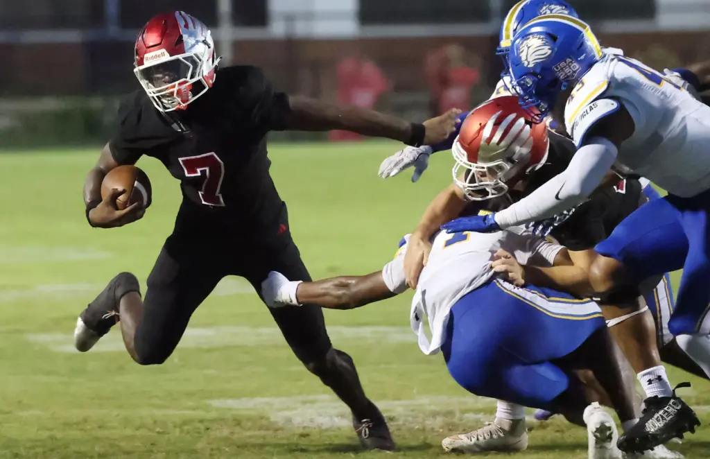 Edgewater running back Jahmari Hammonds (7) runs away from TFA...