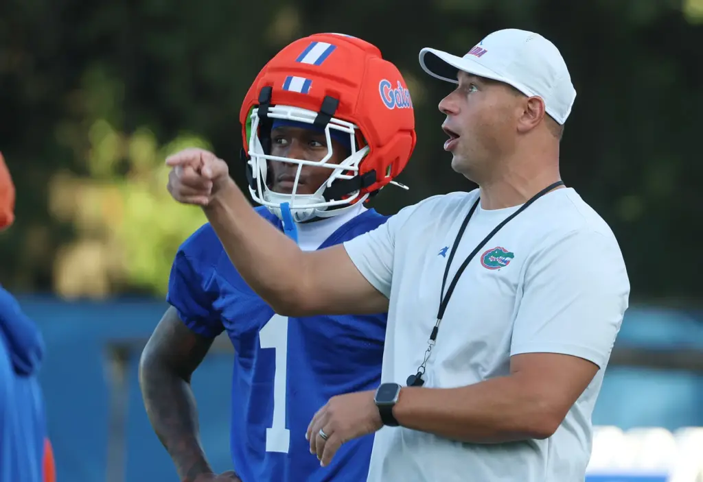 University of Florida head football coach Jon Sumrall (right) points...