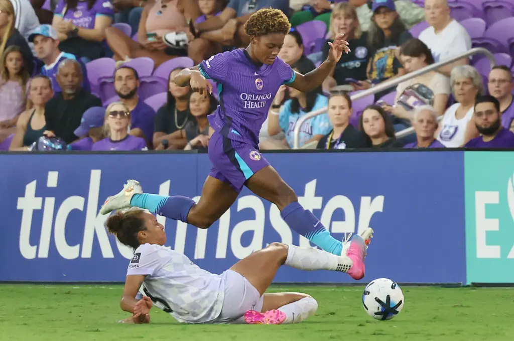 Orlando player Simone Jackson (top) leaps during the Racing Louisville...