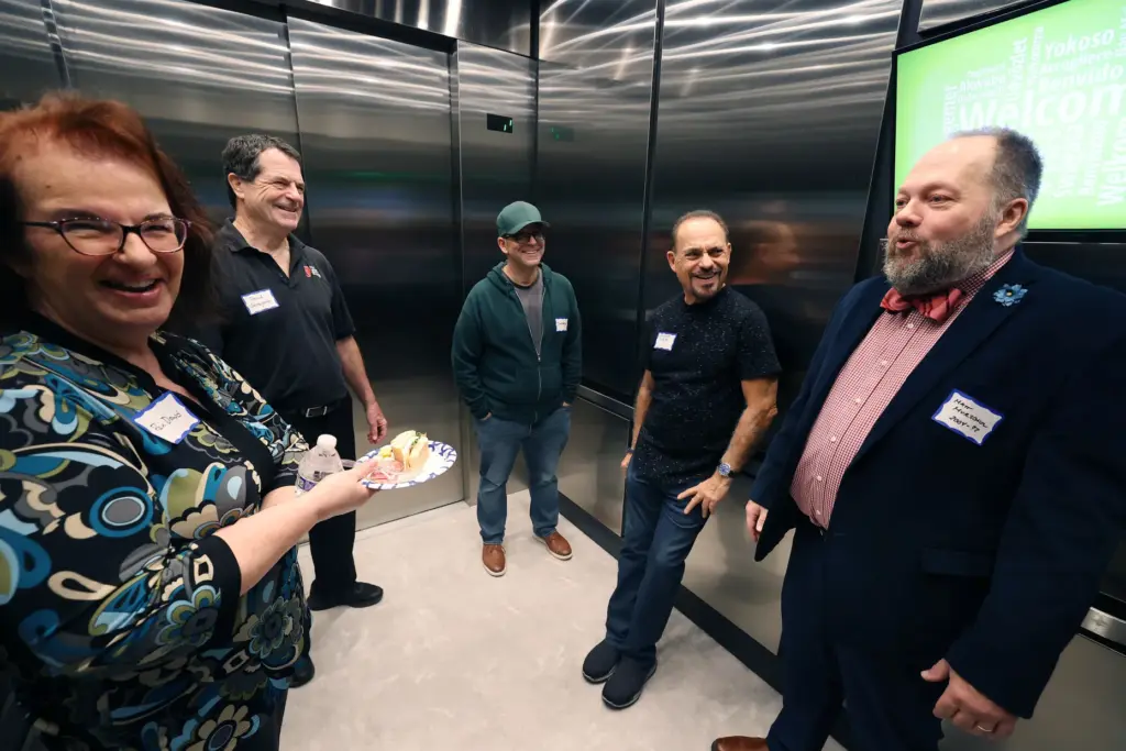 Former and current Orlando Sentinel journalists and employees are pictured...