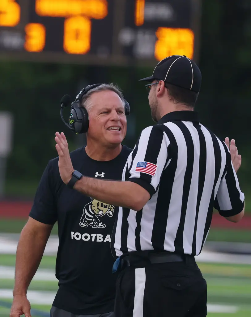 Bishop Moore head coach Matt Hedrick questions a game official...