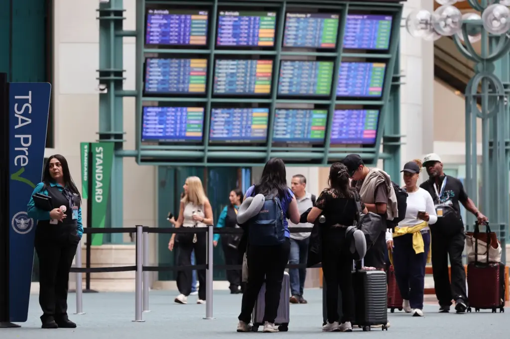 Travelers at the Orlando International Airport, on Labor Day, Monday,...