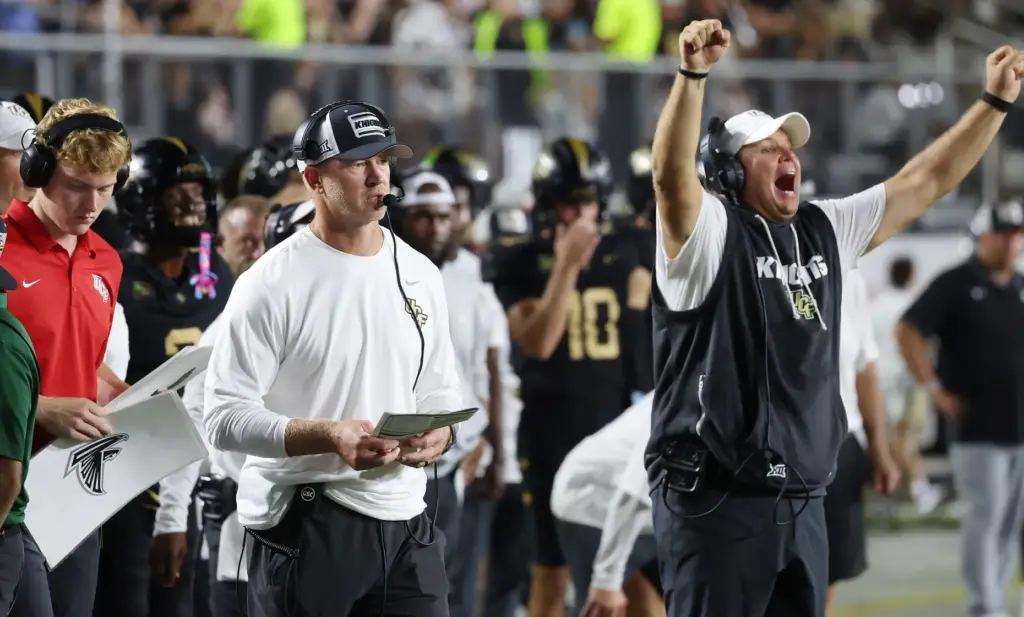 UCF head coach Scott Frost and other coaches react during...