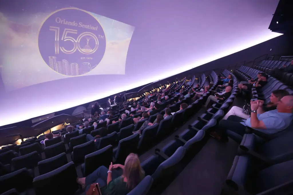 Attendees watch during the Orlando Sentinel presentation of âSpace: Past,...