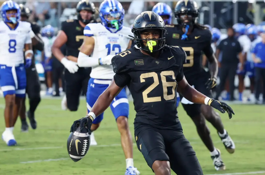 UCF running back Duke Watson celebrates as he scores a...