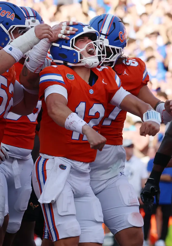 Florida quarterback Aaron Philo (12) screams in celebration after scoring...