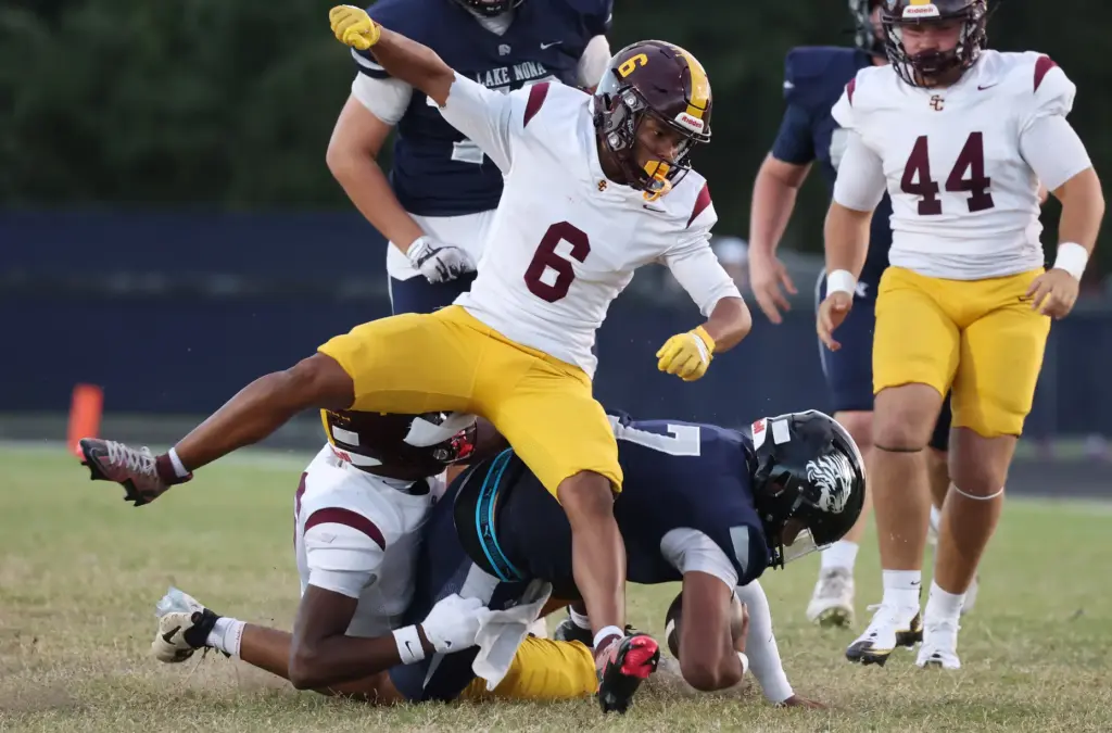 St. Cloud defensive back Jowell Cruz (6) falls onto Lake...