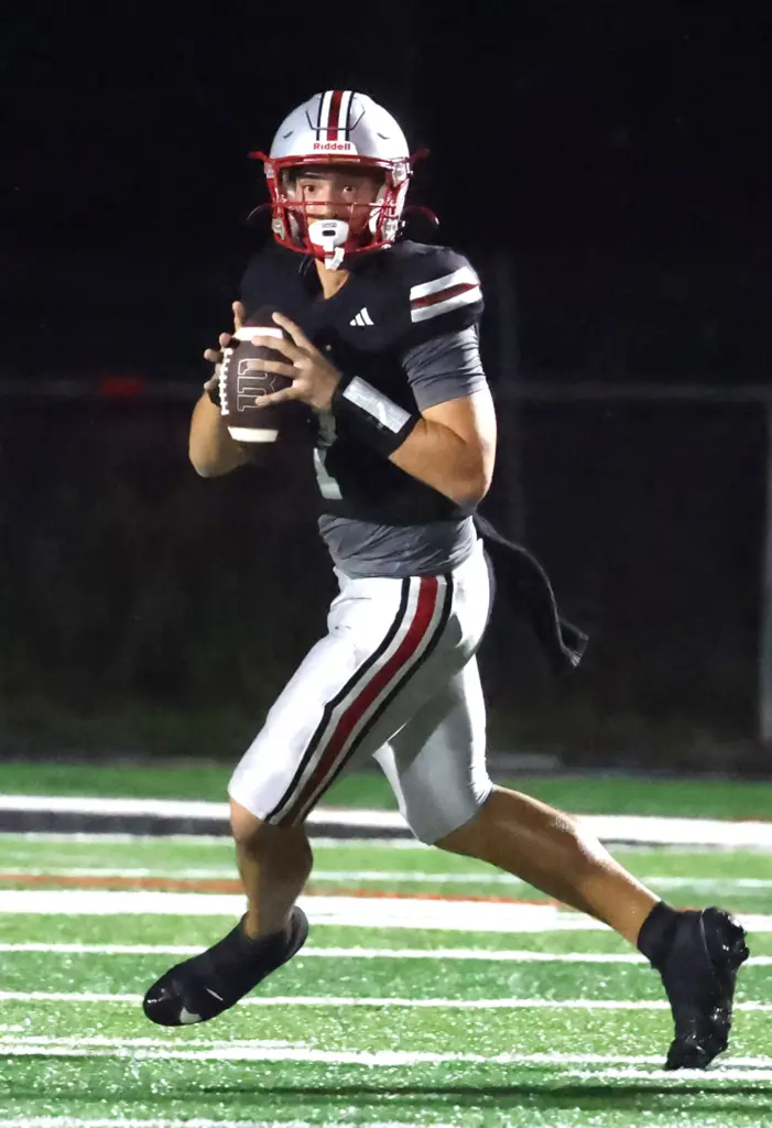 Lake Mary quarterback Remy Jarman looks to throw during the...