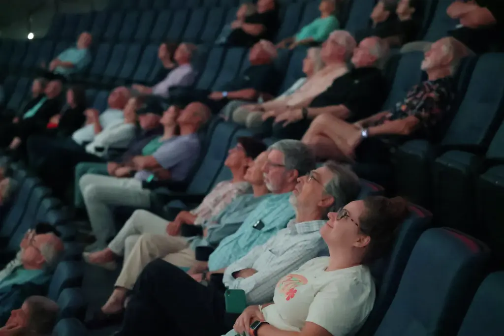 Attendees watch during the Orlando Sentinel presentation of âSpace: Past,...