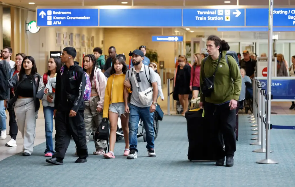 Arriving passengers exit the secure area of the Orlando International...