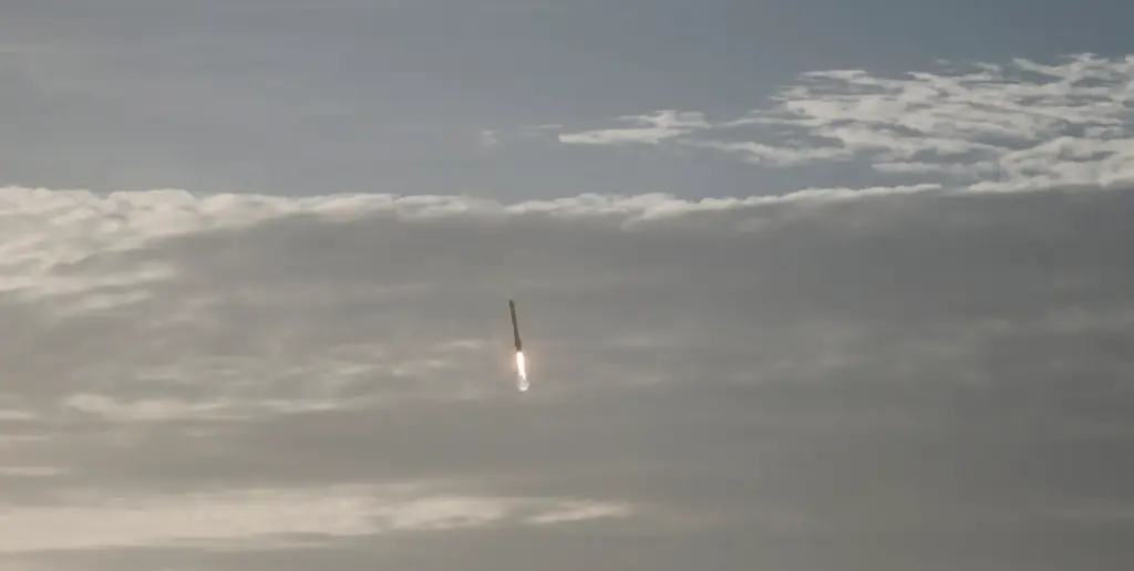 A SpaceX Falcon Heavy booster returns, after helping launch NASA's...